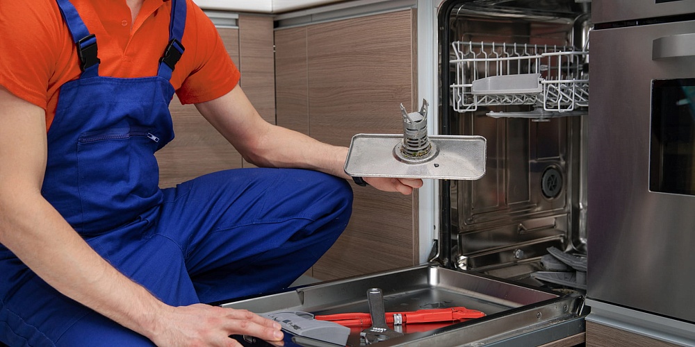 Appliance repair technician at work